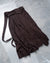A brown full-length pleated skirt with asymmetrical opening and contrast lining, displayed flat.
